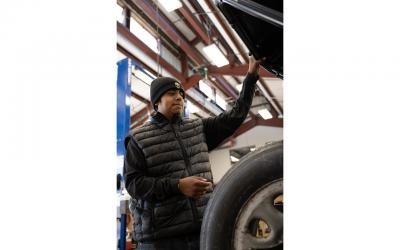 Abel Galindo balancing a wheel on a vintage car