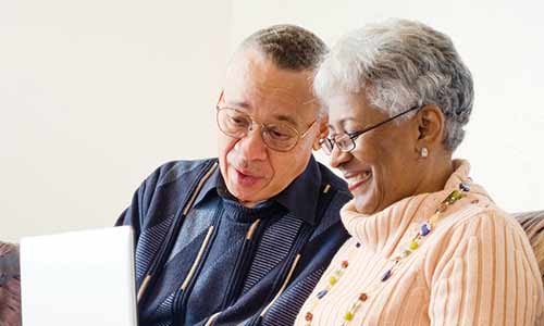Older man and woman looking at the laptop
