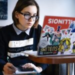 Student with laptop checking financial aid status