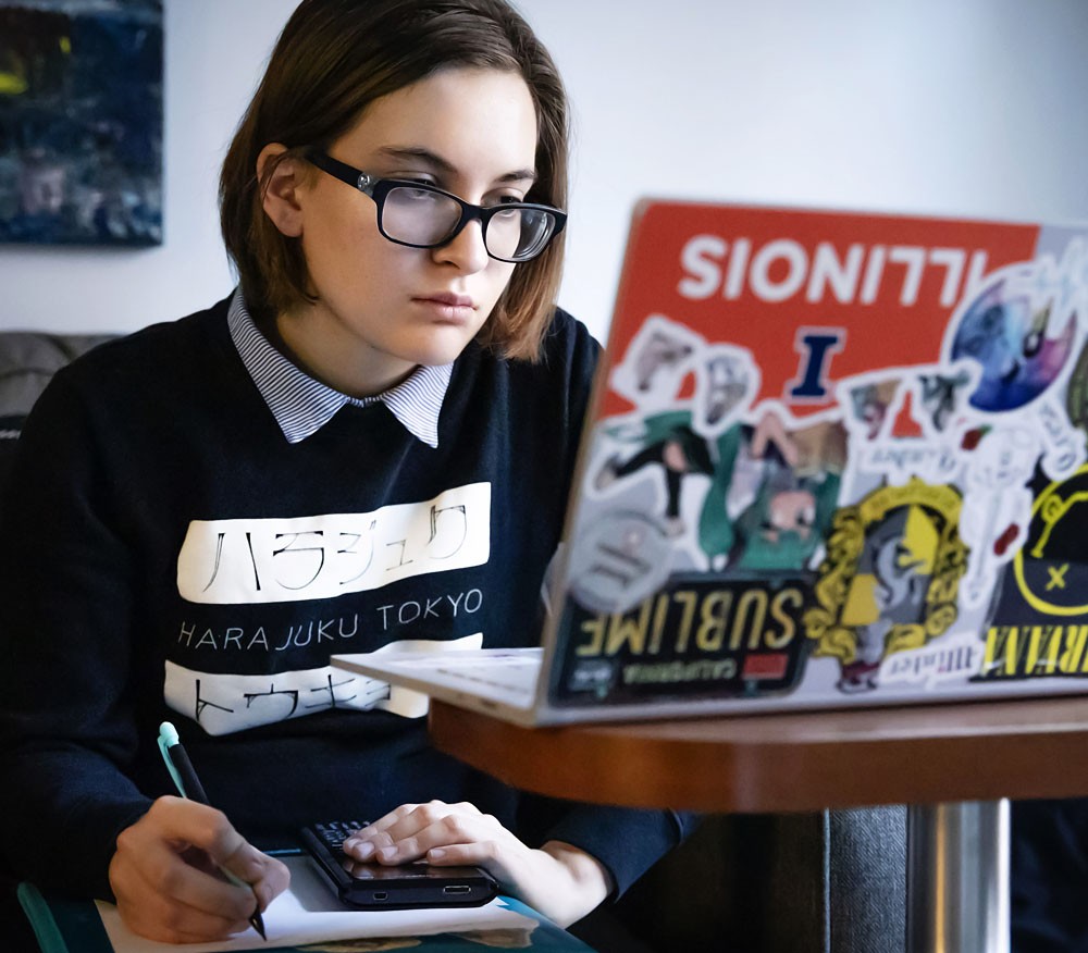 Student with laptop checking financial aid status