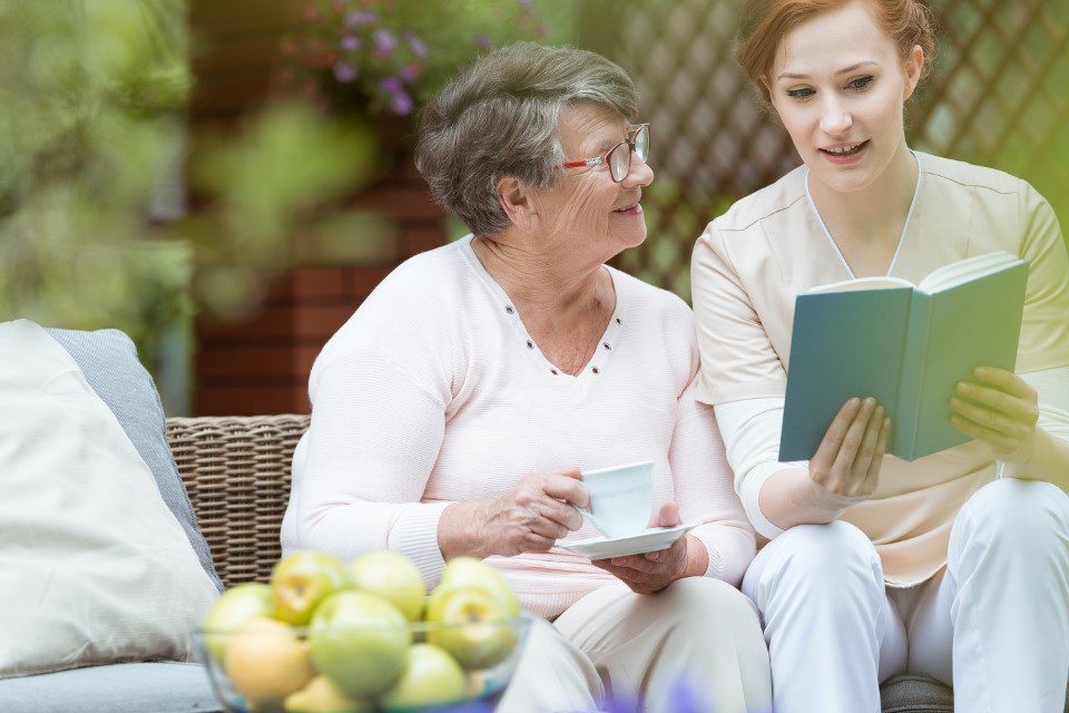 Elderly person enjoying a book, representing the need for clear communication and understanding in software implementation.