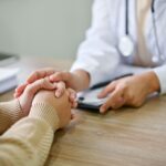 Pharmacist reviewing medication list with a patient