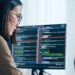 Embedded Software Developer Coding on Multiple Screens