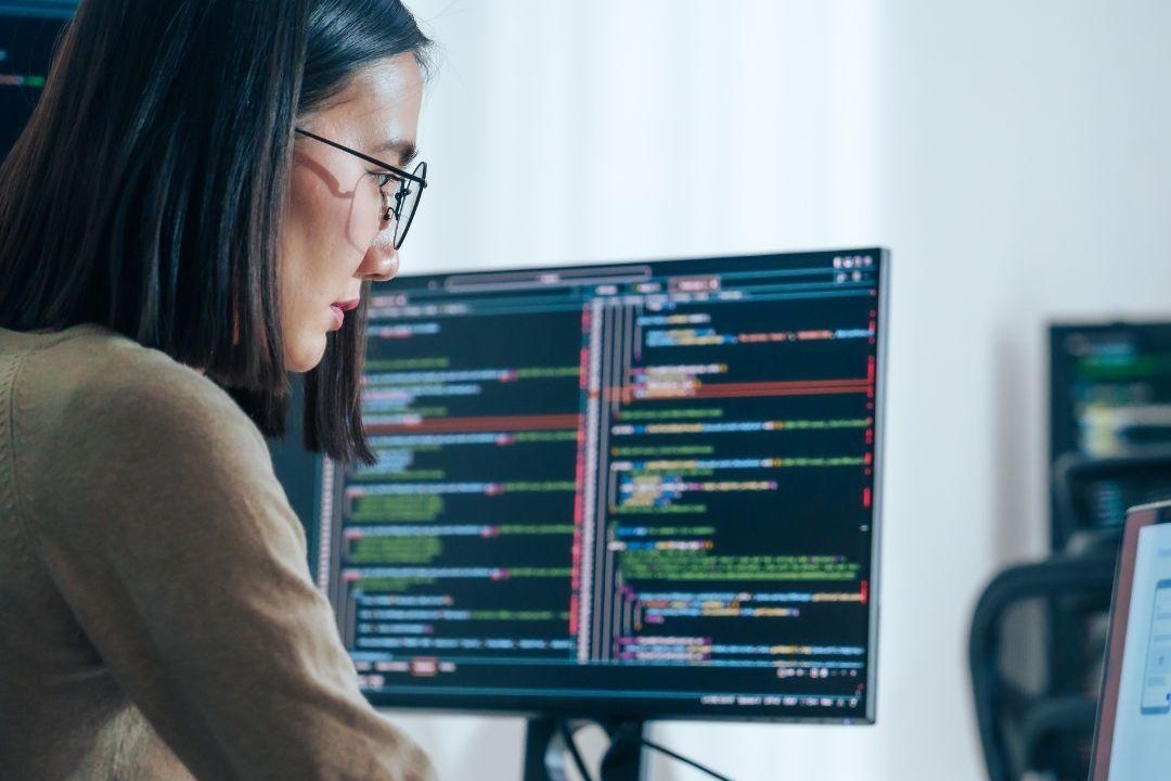 Embedded Software Developer Coding on Multiple Screens