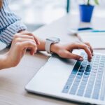 This image shows someone using a computer, representing the importance of carefully planning your donor management software search.
