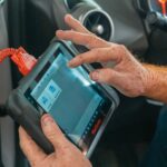 Mechanic using car repair estimating software on a tablet