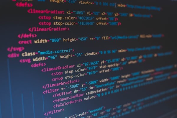 Software developer reviewing code with a mentor, receiving guidance and feedback