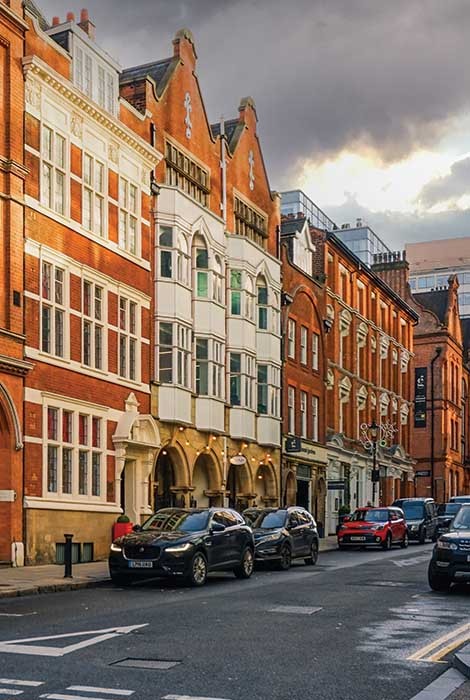 Cars on UK street representing car insurance.