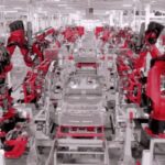 Tesla factory robots assembling a car chassis