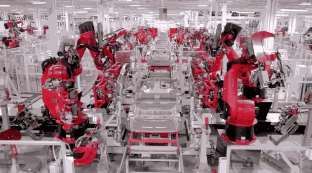 Tesla factory robots assembling a car chassis